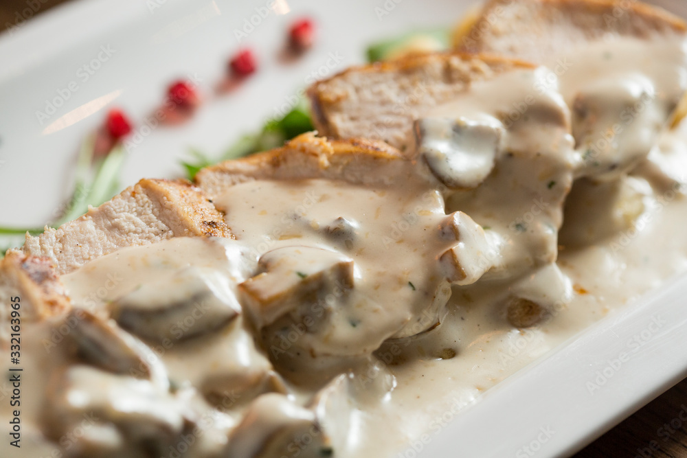 Chicken meat on grated gnocchi in cream sauce of mushrooms and smoked cheese Chicken meat on grated gnocchi in cream sauce of mushrooms and smoked cheese