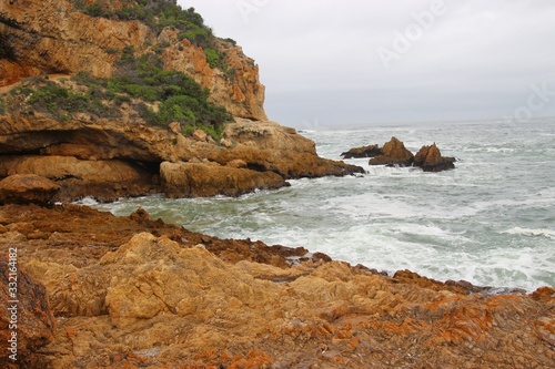 The Knysna Heads, sandstone cliffs that separate the Knysna Lagoon from the pacific ocean. A famous landmark along the renowned Garden Route, South Africa, Africa.