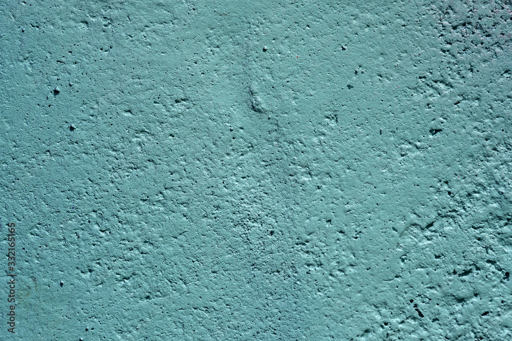 texture of a painted wall. cement plate light aquamarine color background. wall with bumps and small pits. texture of a painted wall. cement plate light aquamarine color background. wall with bumps and small pits.