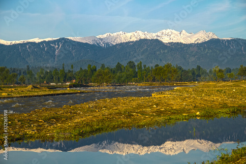 reflection of snow mountains in water in Himalayan ranges in Kashmir India