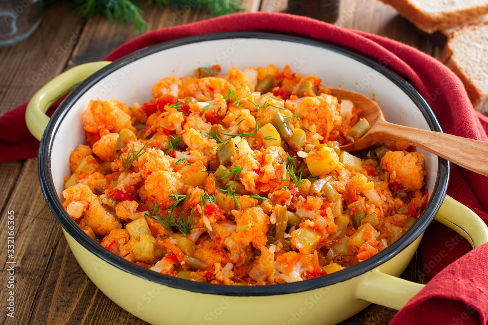 Vegetable stew with cauliflower in an enamel pan, selective focus Vegetable stew with cauliflower in an enamel pan, selective focus