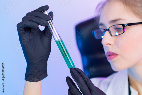 A chemist in black rubber g...