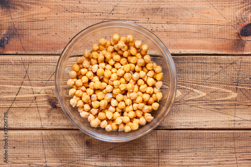 Raw chickpeas pre-soaked in water, top view, selective focus