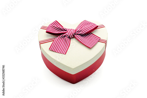 Red-white gift box in heart shape and red ribbon. For giving on special occasion, birthday, valentine, anniversary isolated on white background with clipping path. © Nudphon