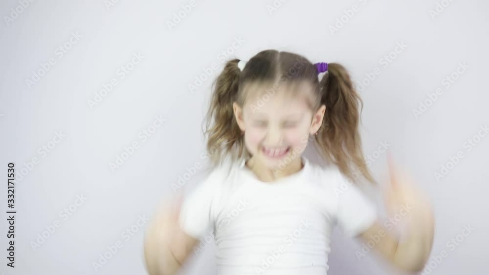 little girl is very happy and shows emotions with her hands. joy, victory, happiness little girl is very happy and shows emotions with her hands. joy, victory, happiness