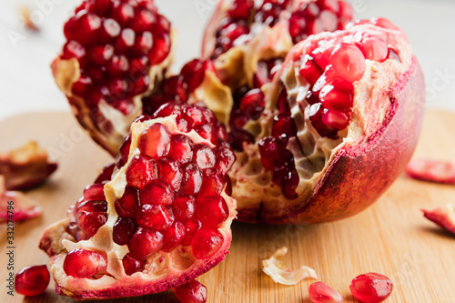 ripe red pomegranate on a white wooden table