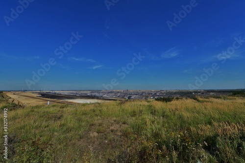 Open pit lignite mining in Germany with machine in the background