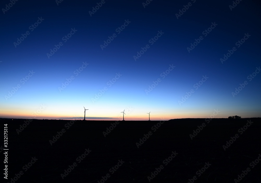 wind generator in the evening mood in Germany as a silhouette wind generator in the evening mood in Germany as a silhouette