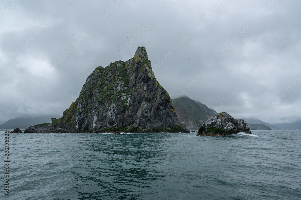 Scenic high rocks in the Pacific Ocean. Kamchatka Peninsula. Scenic high rocks in the Pacific Ocean. Kamchatka Peninsula.