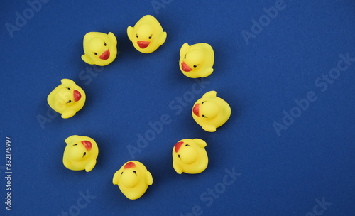 Circle of the rubber ducks on the royal blue background..