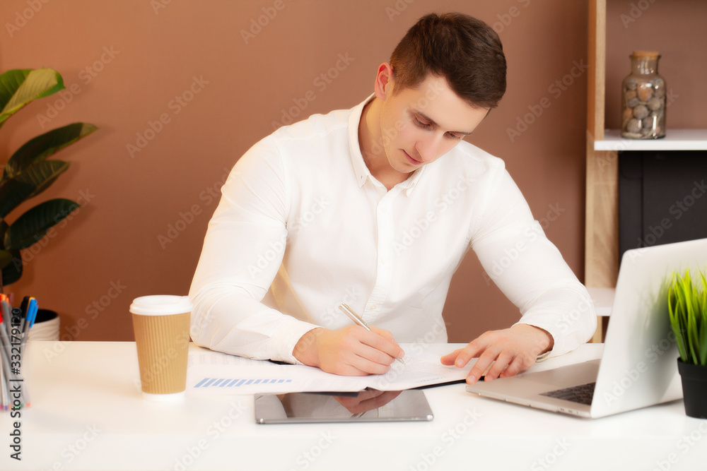 Successful businessman working in the office at the computer. Successful businessman working in the office at the computer.