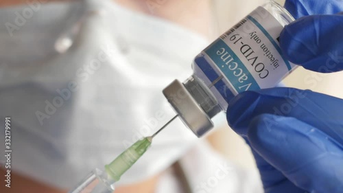 doctor draws vaccine to syringe, vial, covid-19, coronavirus ampoule, injection