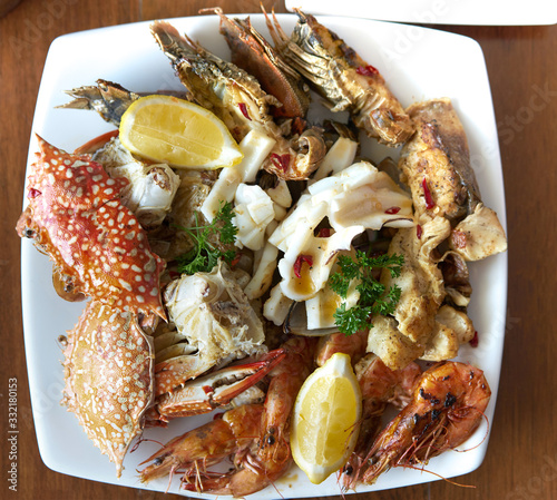 seafood on plate with spocy tasty dipping sauce photo