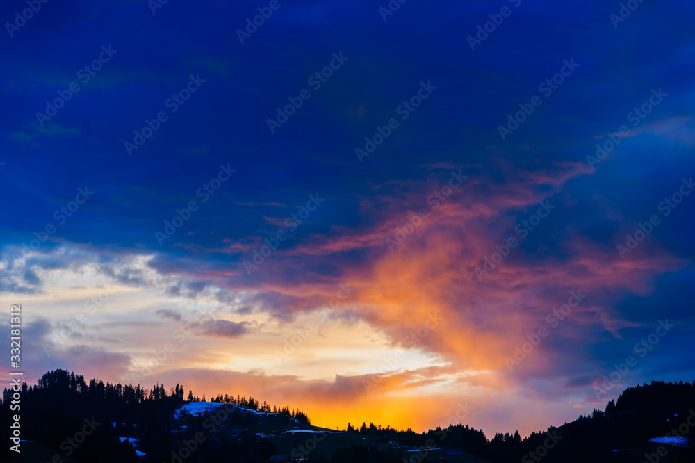 It's a great sunset. Landscape of beautiful multicolored evening sky over the forest