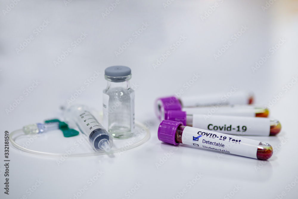 Blood sample tube of coronavirus or covid-19 disease with vaccine testing syringe. Medical and microbiologist science concepth photo. Blood sample tube of coronavirus or covid-19 disease with vaccine testing syringe. Medical and microbiologist science concepth photo.