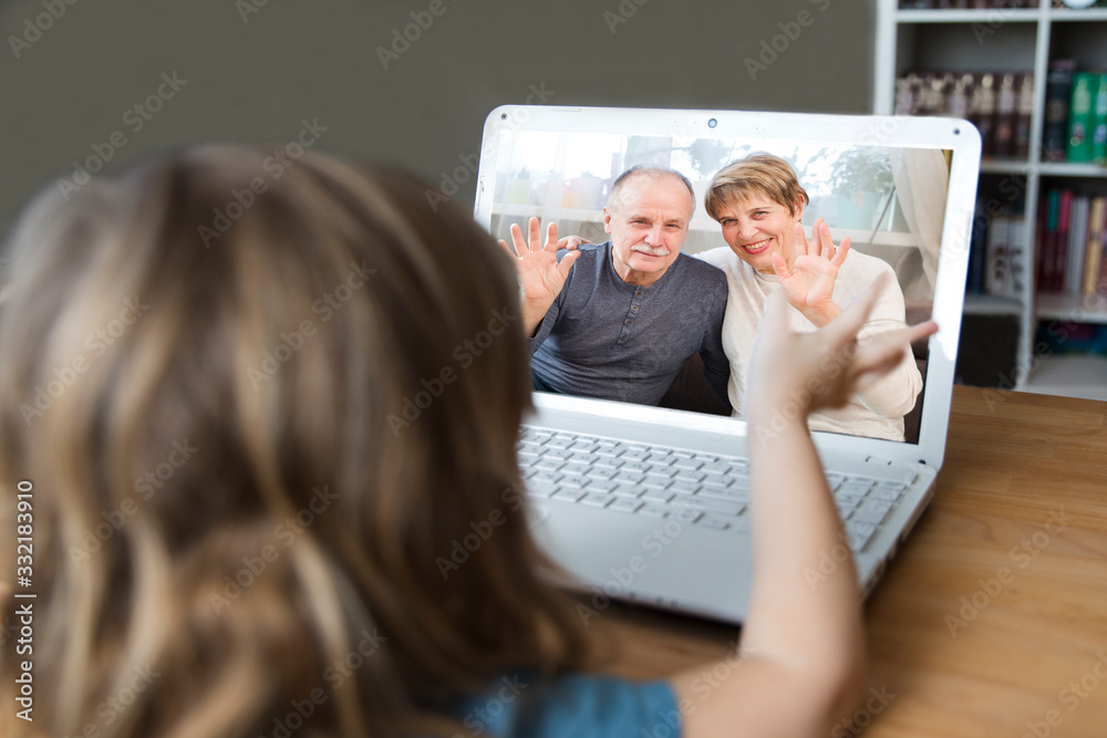 Child using laptop and communicates with grandparents on the Internet.  quarantine. health concept. Corona Virus. 