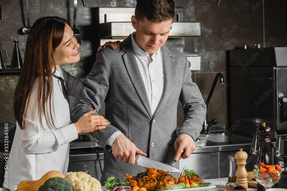 caucasian married couple at the master class with professional cook in kitchen, young couple in culinary lessons, cut delicious dish caucasian married couple at the master class with professional cook in kitchen, young couple in culinary lessons, cut delicious dish