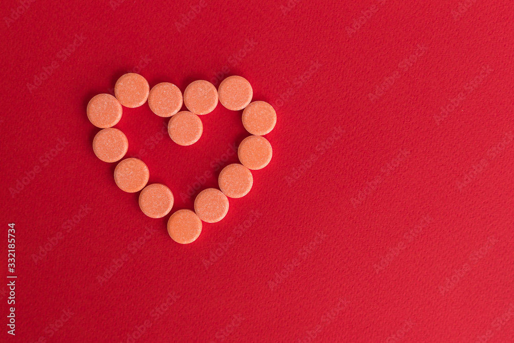 Healthy concept with Pharmaceutical medicine pills, tablets and capsules on red background. Medicine hert love creative concepts. medical pattern, top view, flat lay. Copy space