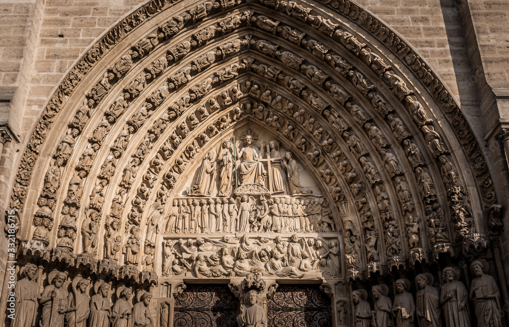 Detail of the main arch on the west facade of Notre Dame Cathedral, Paris, France. Taken on a warm and sunny afternoon in the Autumn
