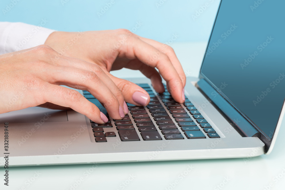 doctor's hand is typing the data into the system. Using a laptop computer doctor's hand is typing the data into the system. Using a laptop computer