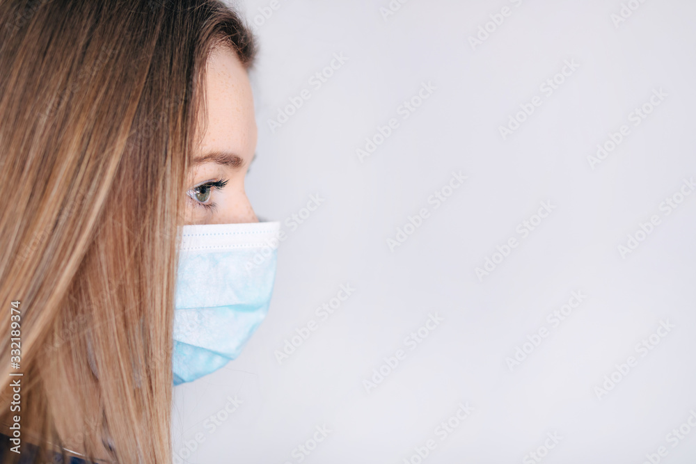 Woman in mask against viruses in profile. Concept of the fight against coronovirus infection, self-isolation, quarantine. Woman in mask against viruses in profile. Concept of the fight against coronovirus infection, self-isolation, quarantine.