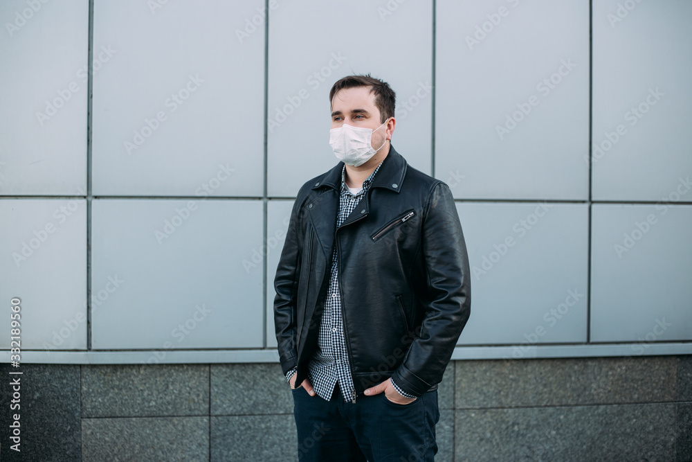 COVID-19 Pandemic Coronavirus Man in city street wearing face mask protective for spreading of Coronavirus Disease 2019. Portrait of man with surgical mask on face against SARS-CoV-2 COVID-19 Pandemic Coronavirus Man in city street wearing face mask protective for spreading of Coronavirus Disease 2019. Portrait of man with surgical mask on face against SARS-CoV-2