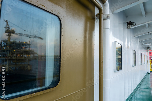 Glass window of a cabin on board a construction work barge aat oil field