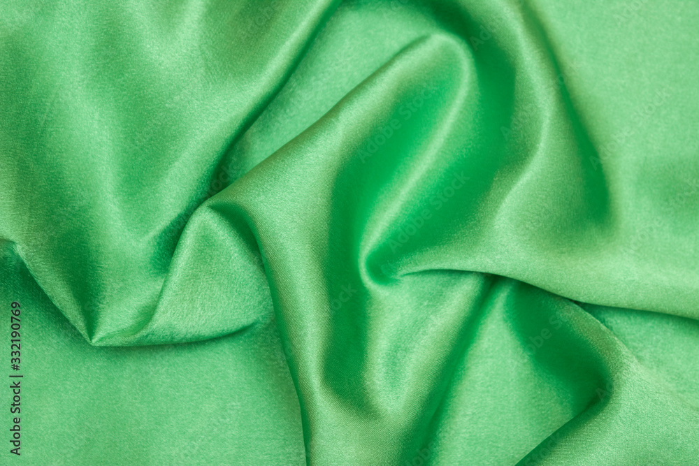 Smooth elegant green silk or satin luxury cloth texture can be used as an abstract background. Crumpled fabric. Smooth elegant green silk or satin luxury cloth texture can be used as an abstract background. Crumpled fabric.