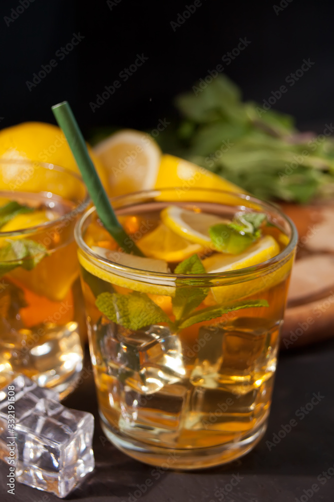 Two glasses of cold refreshment tea with ice and lemon fruit. Two glasses of cold refreshment tea with ice and lemon fruit.