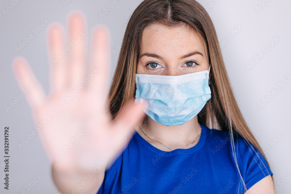 Close up of woman wearing protective face mask, get ready for Coronavirus and pm 2.5 fighting and show stop hands gesture for stop corona virus Close up of woman wearing protective face mask, get ready for Coronavirus and pm 2.5 fighting and show stop hands gesture for stop corona virus