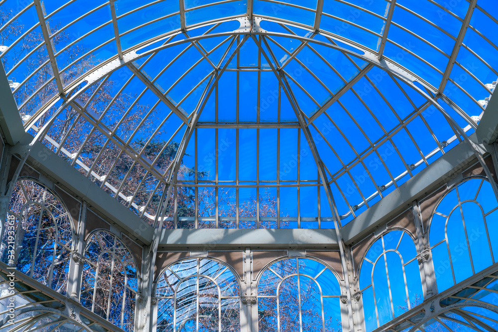 interior of greenhouse in garden with transparent glass roof.