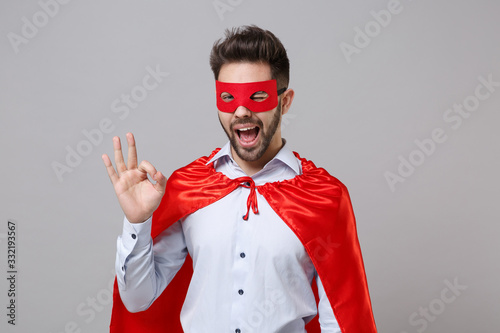 фотографія Blinking powerful business man in shirt superhero suit have supernatural abilities isolated on grey background