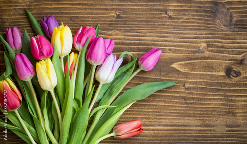 Spring tulips bouquet on wooden background with copy pace  spring greeting