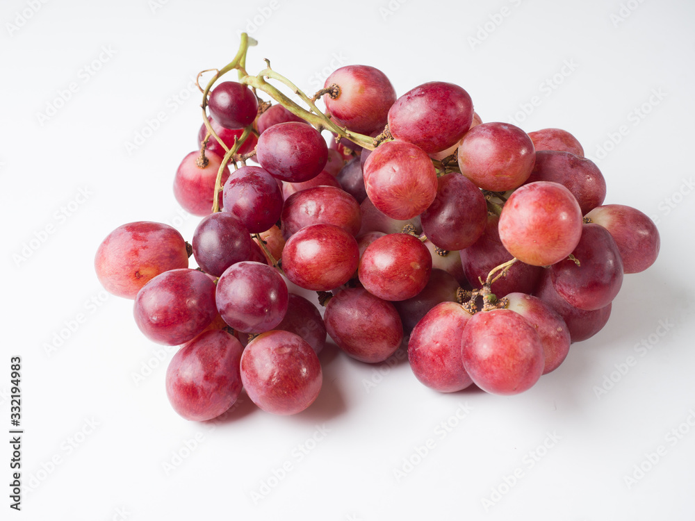 A bunch of pink large grapes on a white background. Studio photography