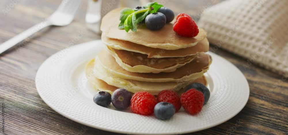Food and Cooking Concept. Stack of pancakes with fresh berry, rotate shot
