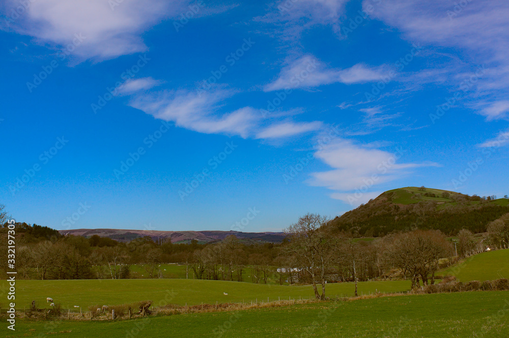landscape with green field, blue sky, and hills landscape with green field, blue sky, and hills