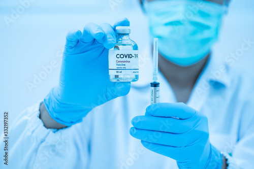 Doctor's hand holding syringe and bottle for vaccine to patient .Vaccination against coronavirus quarantine or covid-19.Protection against virus and infection control.Medication treatment concept.