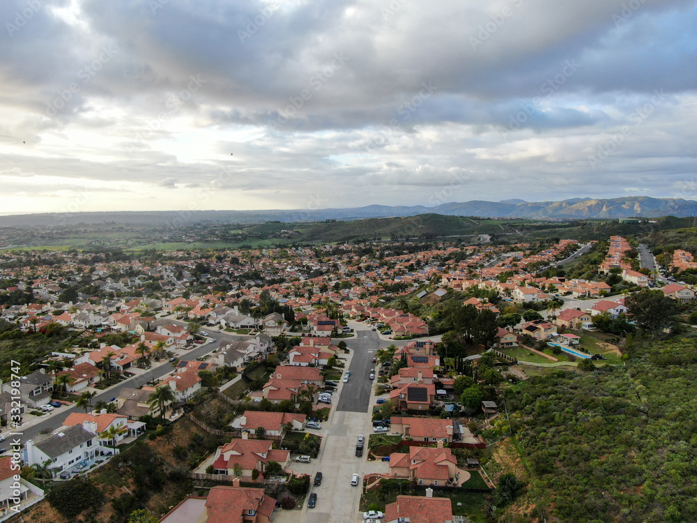 Aerial view of upper middle class neighborhood with residential subdivision houses during clouded day in San Diego, California, USA.
