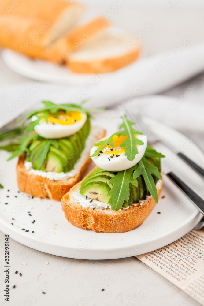 Toast with avocado, arugula and egg. Healthy Breakfast. Toast with avocado, arugula and egg. Healthy Breakfast.