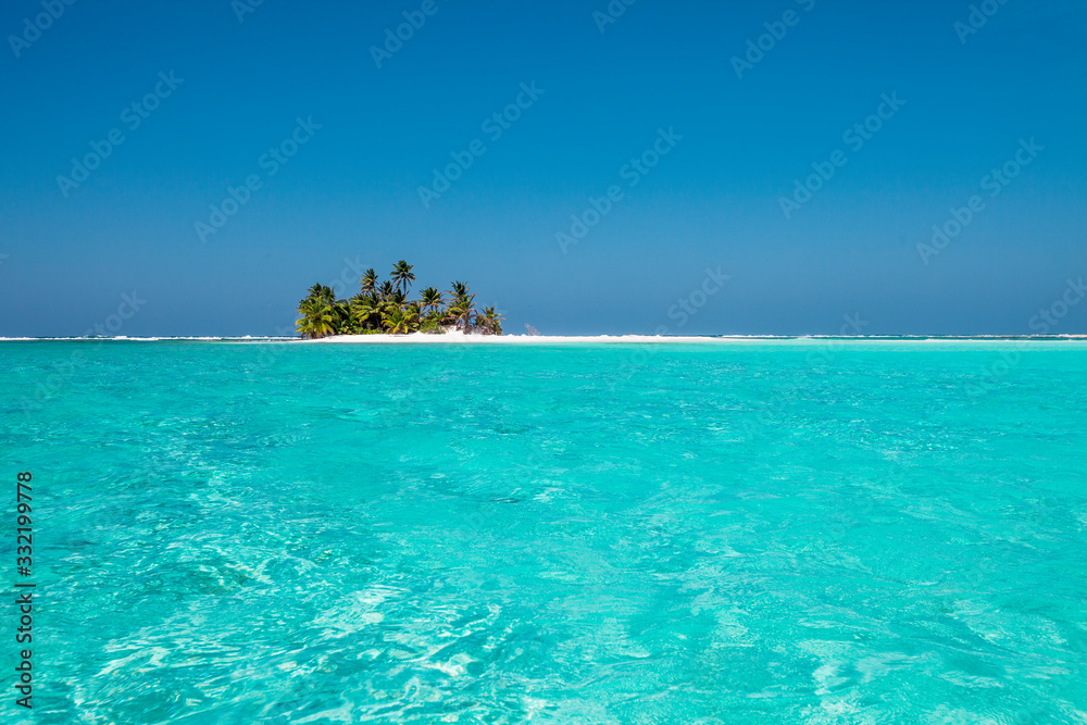 tiny little sandy island with palm tree and white sand beach in the turquoise lagoon of Cocos Keeling atollm landscapephotography - obrazy, fototapety, plakaty 