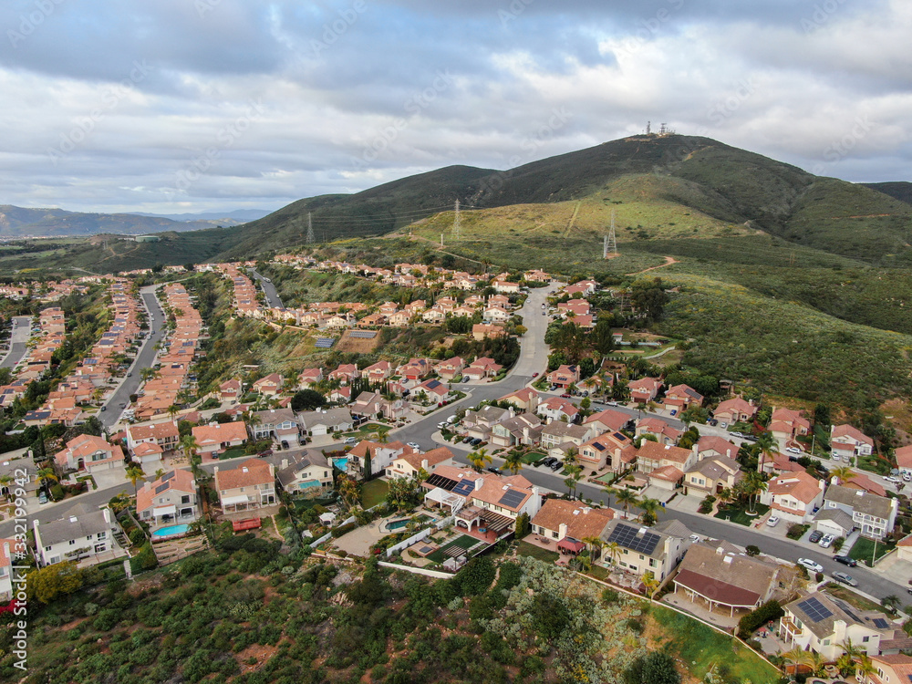 Fototapeta premium Aerial view of upper middle class neighborhood with residential subdivision houses during clouded day in San Diego, California, USA.