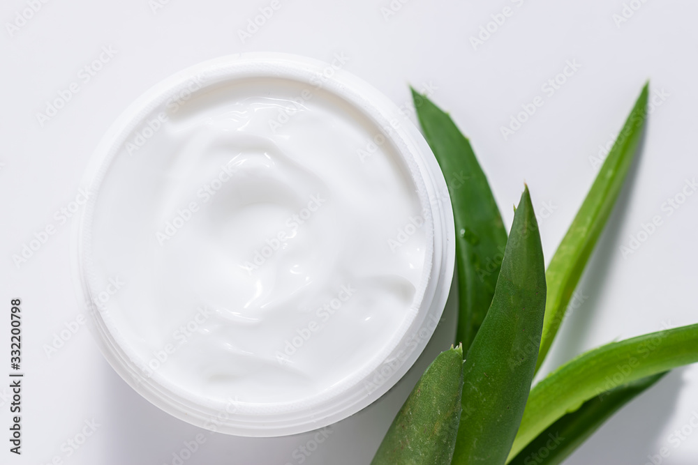 Organic moisturizing cream with Aloe Vera extract for face care on white background top view. Natural cosmetic concept.