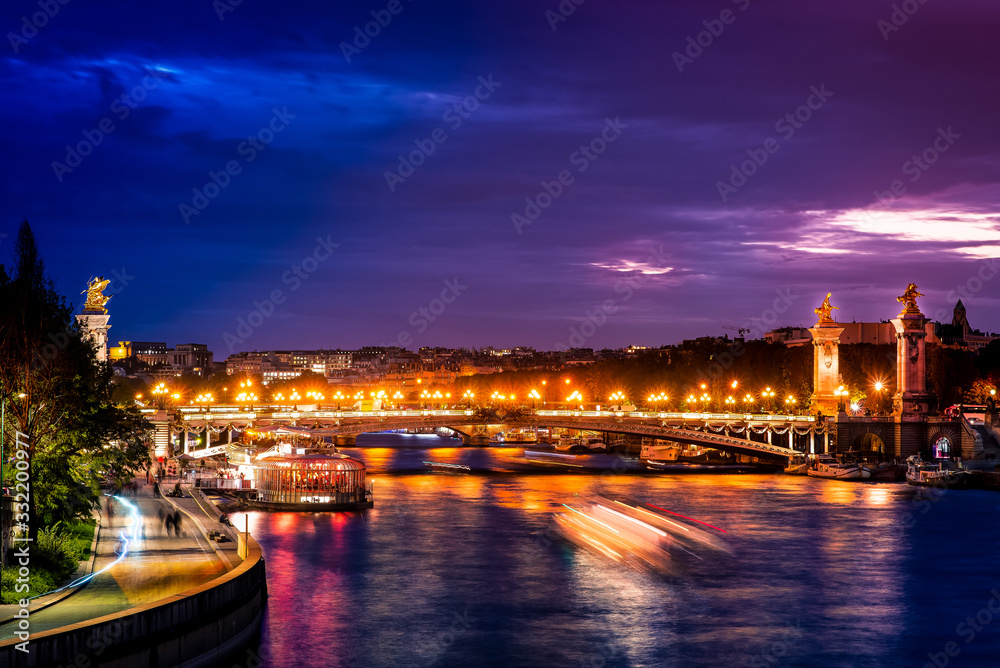 Pont Alexandre III and the Parisian night from Pont de la Concorde, looking at river Seine