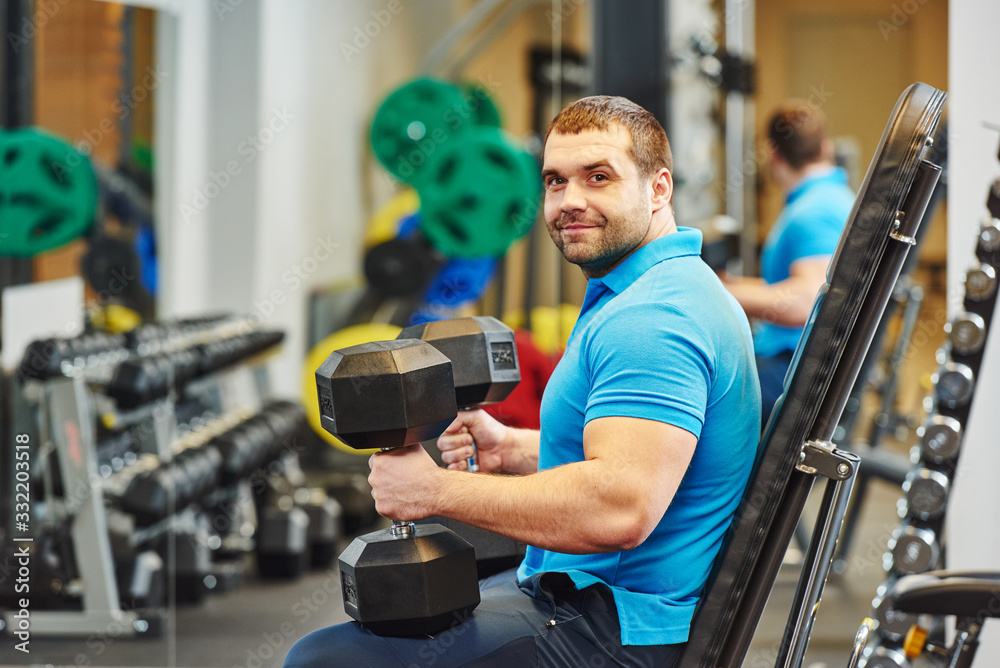 male fitness trainer or bodybuilder at gym male fitness trainer or bodybuilder at gym
