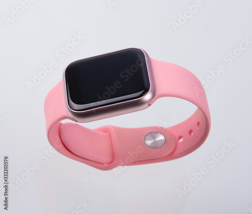 Pink wireless Smart Watch isolated on white background