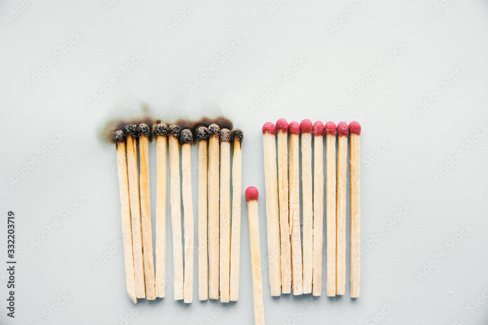 concept to stop the coronavirus COVID-19 from spreading -Matchsticks burn and one piece prevents fire from spreading, Social distance or stay at home concept to stop the coronavirus COVID-19 from spreading -Matchsticks burn and one piece prevents fire from spreading, Social distance or stay at home