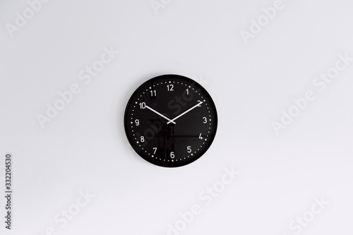 black clock on white wall