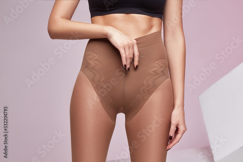 Bilde på lerret Part of woman body perfect shape hips legs skin tan wear stockings, nylons, pantyhose lingerie hosiery hose studio shot on white background