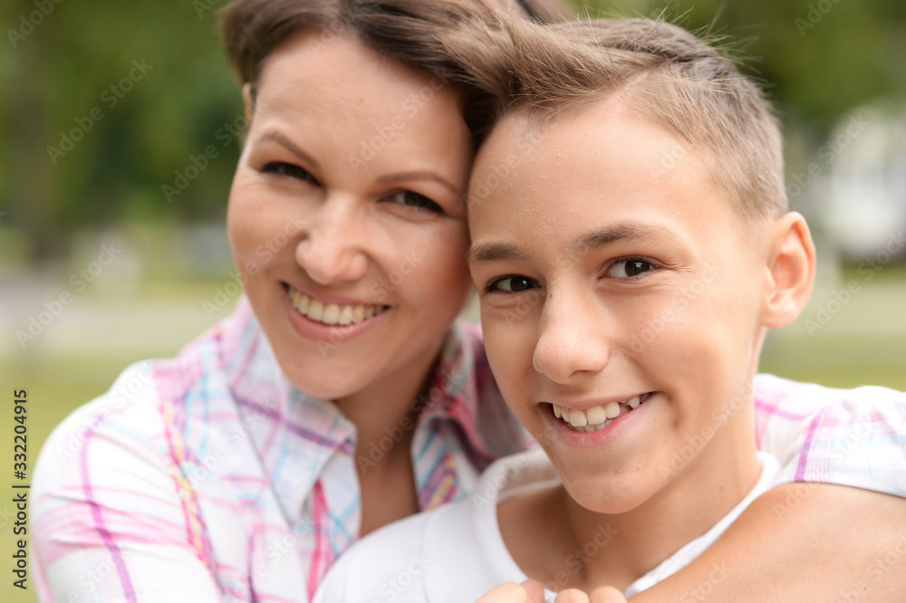 Close up portrait of beautiful mother with son in park Close up portrait of beautiful mother with son in park