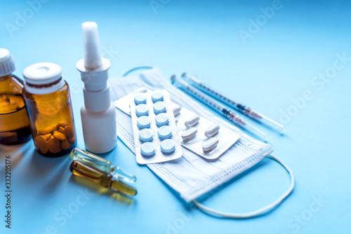 Tablets, pack of medicines with medicine bottles on a blue background. Pharmacy theme.